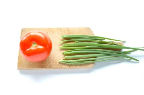 Vegetables on chopping board on white background Stock Photos