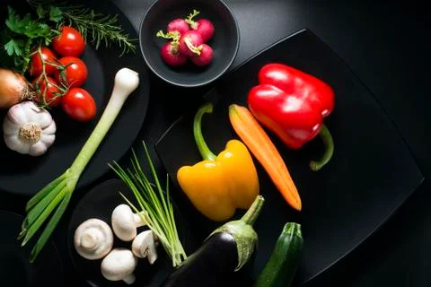 Vegetables collection on black table Stock Photos