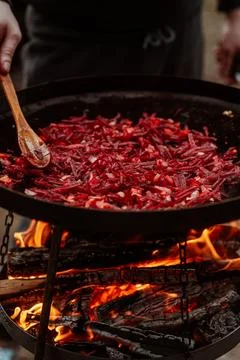Vegetables cooked on a grill pan over an open fire in the woods. Cooking Stock Photos