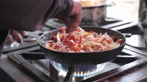 Vegetables Cooking Cast Iron Pan Skillet Stove Gas Fire Flame Mixing Spoon Vídeos de archivo 336669458
