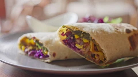 Vegetables, corn, cabbage wrapped in pita bread. Vegan Shawarma. Close up Video stock 250165413