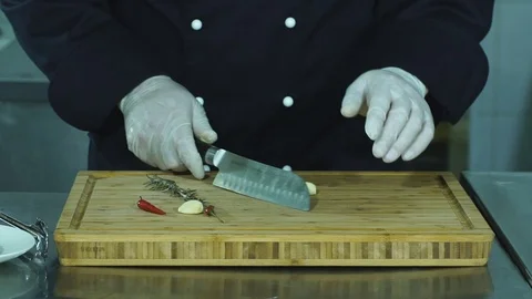 Vegetables on cutting board and chef hands detail, restaurant kitchen on Stock Footage 71025847