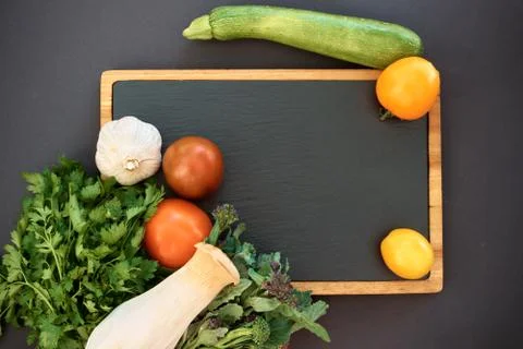 Vegetables dark background with copy space. Healthy meal. Menu, price backgro Stock Photos