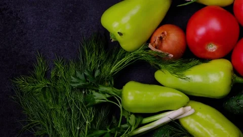 Vegetables on a dark background on which a fly is crawling, top view. The Stock Footage 167280563