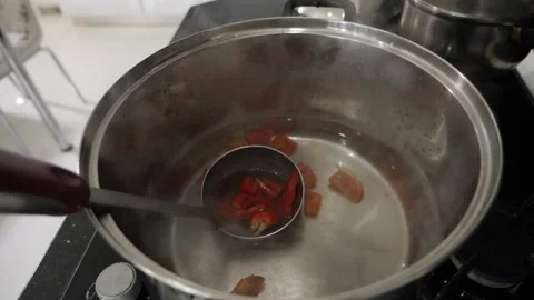 Vegetables that fall into the pot with boiled water and ladle Stock Footage 137211304
