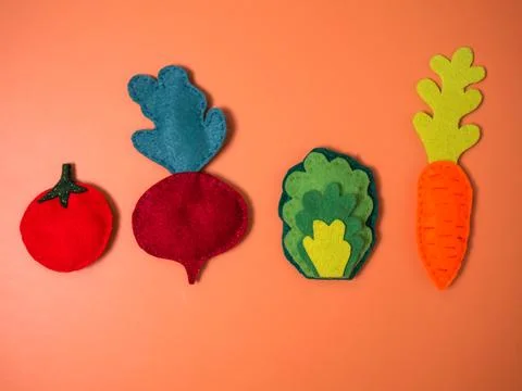 Vegetables from felt on an orange background Stock Photos