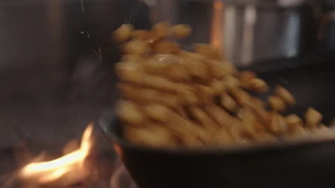 Vegetables flying into the pan, Apple on a clarified butter in a pan  Stock Footage 172073418