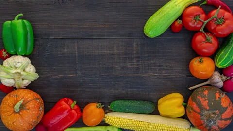 Vegetables frame on black wooden background, stop motion animation, 4K Stock Footage 141426013