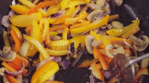 Vegetables fried in a pan are stirred with a spatula 库存影片 149246849
