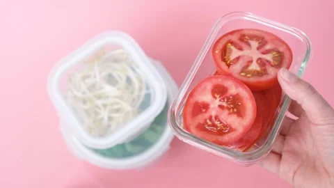Vegetables in glass containers on pink background, food storage concept. Stock Footage 241484886