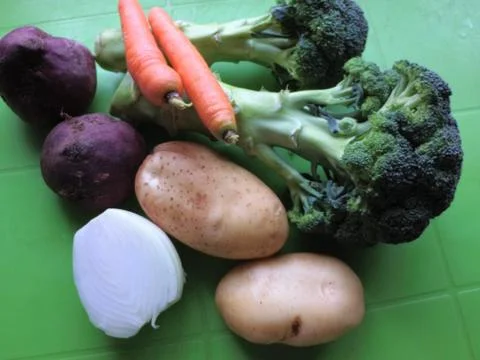 Vegetables on a green background, broccoli, beets, carrots. Healthy food Stock Photos