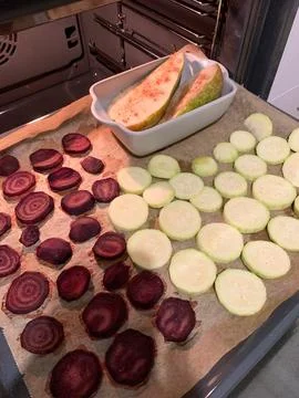 Vegetables including beetroot, zucchini and pear are prepared on a baking t.. Stock Photos