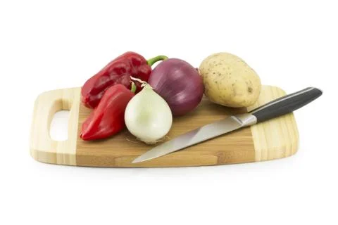 Vegetables on a kitchen board with knife Stock Photos