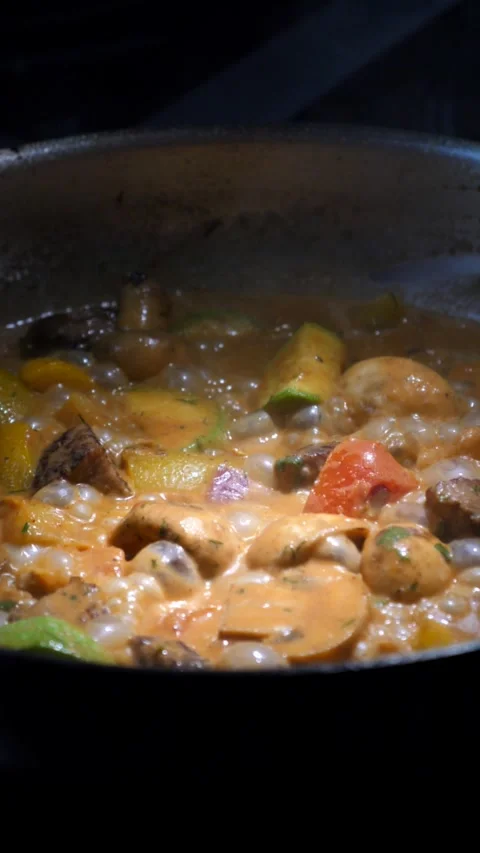 Vegetables with meat are fried in a frying pan Stock Footage 309463564
