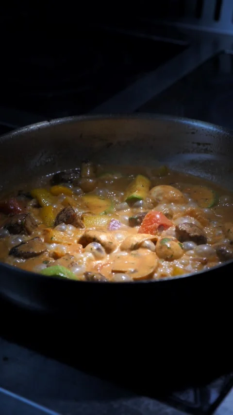 Vegetables with meat are fried in a frying pan Stock Footage 309463569