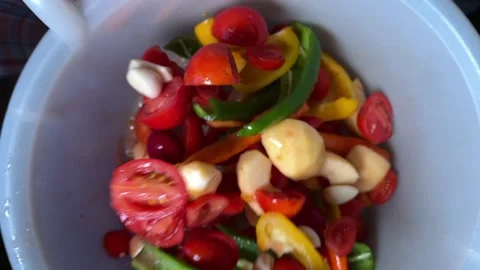 Vegetables mixed in slow motion in the container Stock Footage 220740538