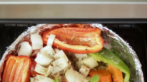 Vegetables into oven each vegetable piece glowing with roasted texture and color Stock Footage 319843478