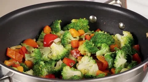 Vegetables in a pan being quenched with vegetable stock (close-up) Stock Footage 24672885