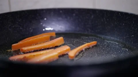 Vegetables in a pan cook carrots in the kitchen Stock Footage 142035662