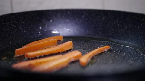 Vegetables in a pan cook carrots in the kitchen Stock Footage 142035664