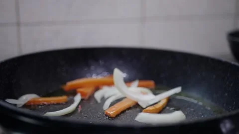 Vegetables in a pan cook carrots in the kitchen Stock Footage 142035678