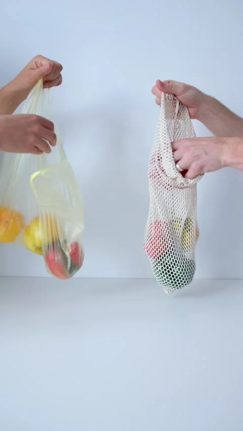 Vegetables in a plastic bag vs reusable in organic eco-cotton mesh Stock Footage 238643549