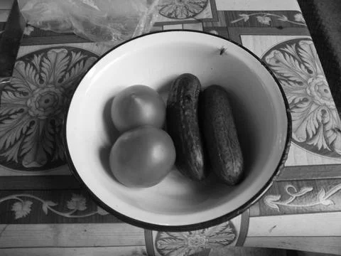 Vegetables on a plate and table Stock Photos