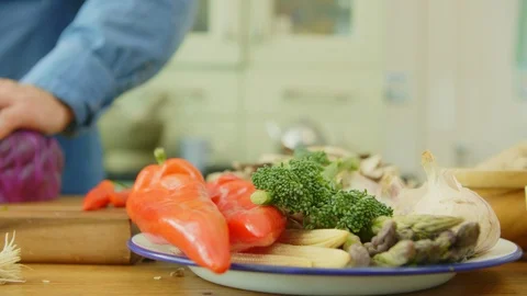 Vegetables In Plate By Man Cutting Red Cabbage At Kitchen Stock Footage 86115568