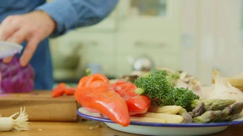 Vegetables In Plate By Man Cutting Red Cabbage At Kitchen Stock Footage 86115612