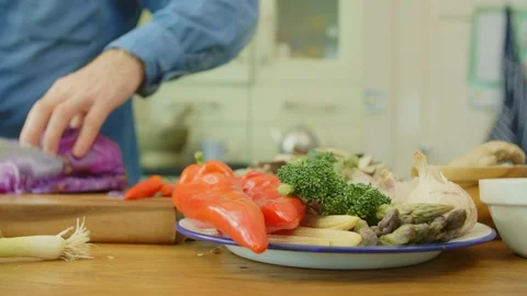 Vegetables In Plate By Man Cutting Red Cabbage At Kitchen Stock Footage 86115656