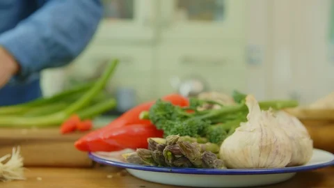 Vegetables In Plate By Man Cutting Spring Onion At Kitchen Stock Footage 86115488