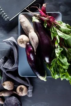 Vegetables on a plate with notebook from the top Foto stock
