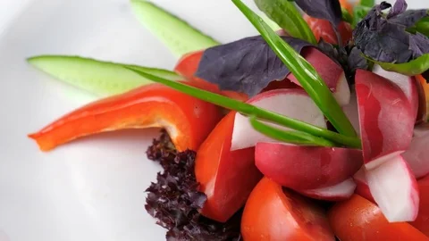 Vegetables plate, raw sliced cucumber, tomato, radish and bell pepper, close-up Video stock 84262119