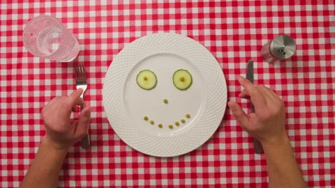 Vegetables in a Plate Top down view and male hands with a fork and knife. Stock Footage 241763955