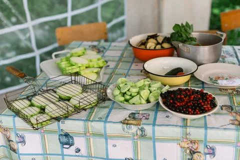 Vegetables prepared on a table in a garden setting for a summer cooking activity Stock Photos