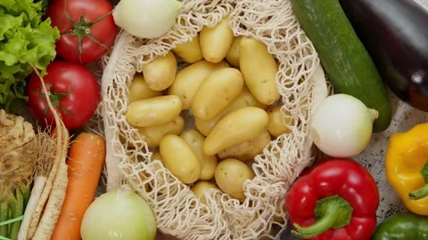 Vegetables in reusable net bags on white scratched background, top view. Zero Stock Footage 154731053