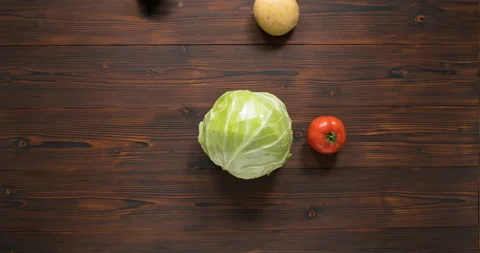 Vegetables revolve around cabbage like planets revolving around a star Stock Footage 127788002