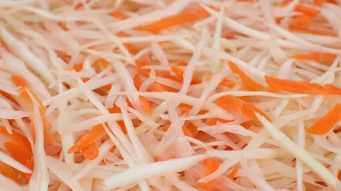 Vegetables salad with sliced white cabbage and carrot top view. coleslaw salad Video stock 143855829