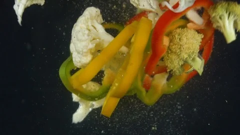 Vegetables splash in water on black background Stock-Footage 85273869