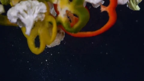 Vegetables splash in water on black background HD Stock-Footage 85273983