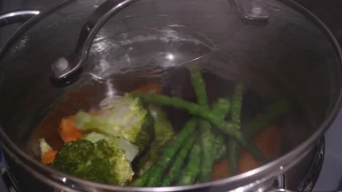 Vegetables in steamer on cooker Stock Footage 142632717