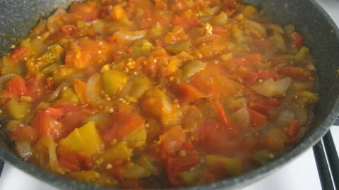 Vegetables stew cooking in frying pan on kitchen close up view. Stock Footage 312468485
