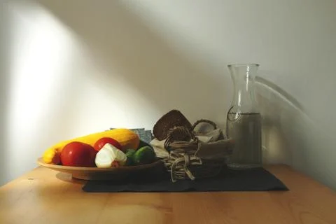 Vegetables on the table and bread and a bottle of water. Stock Photos