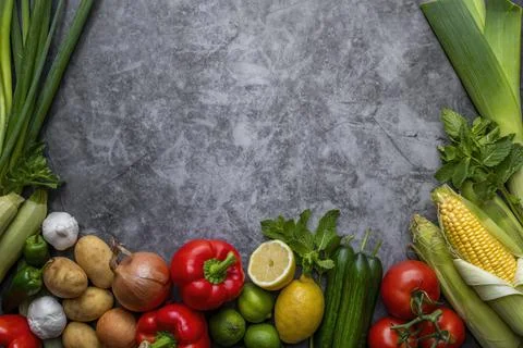 Vegetables on table  and in the center a empty writing space.Cooking concept. Stock Photos