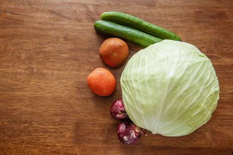 Vegetables on the table. cabbage red onion cucumber tomato. A simple appetize Stock Photos