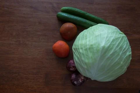 Vegetables on the table. cabbage red onion cucumber tomato. A simple appetize Stock Photos