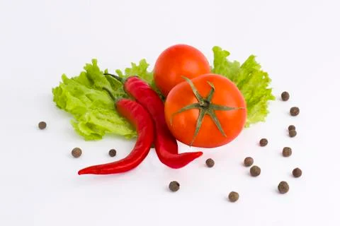 Vegetables on a white background. Cucumbers with tomatoes and garlic on a whi Stock Photos