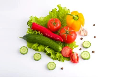 Vegetables on a white background. Cucumbers with tomatoes and garlic on a whi Stock Photos