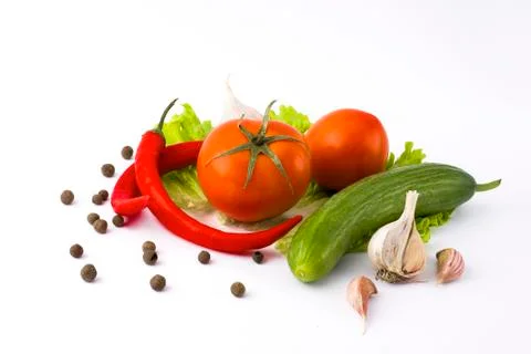 Vegetables on a white background. Cucumbers with tomatoes and garlic on a whi Stock Photos