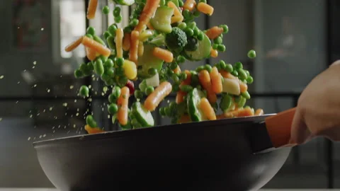 Vegetables on wok Stock Footage
